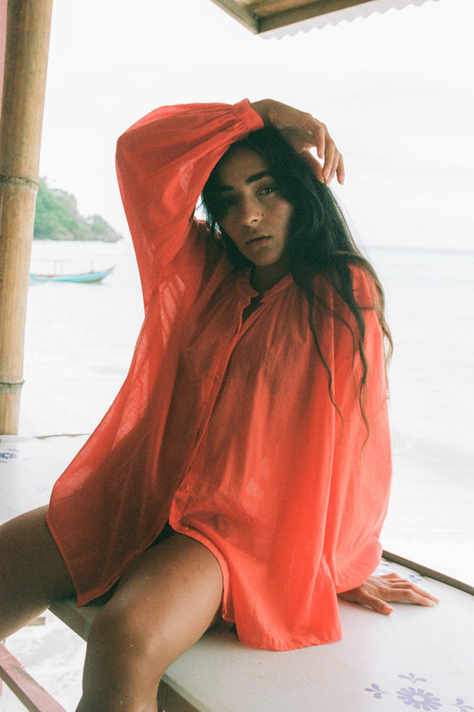 LILLY PILLY woman wearing a spritz Ember cotton voile shirt by the seaside