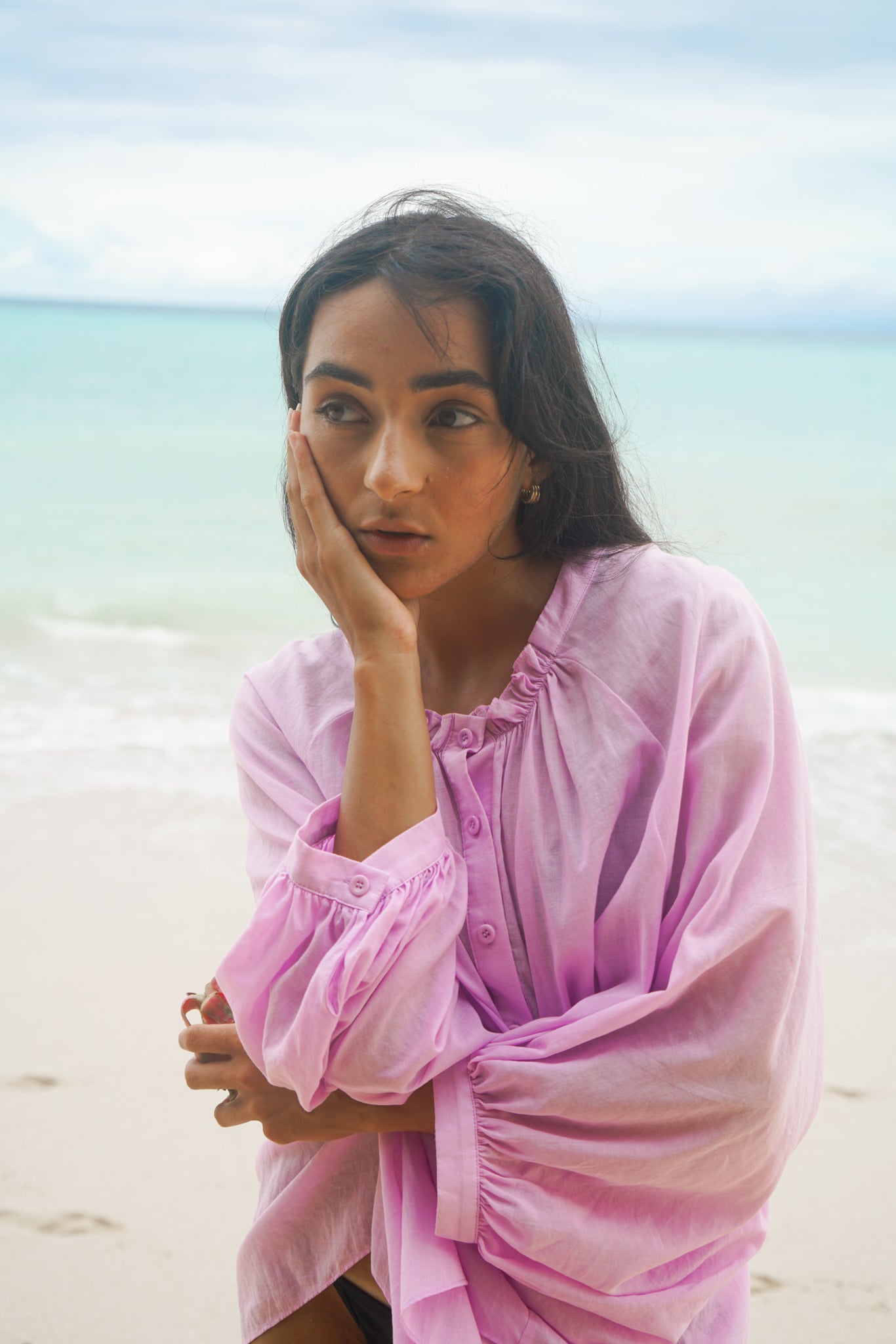 LILLY PILLY woman wearing a orchid Thalia cotton voile shirt blouse with her arms crossed by the seaside