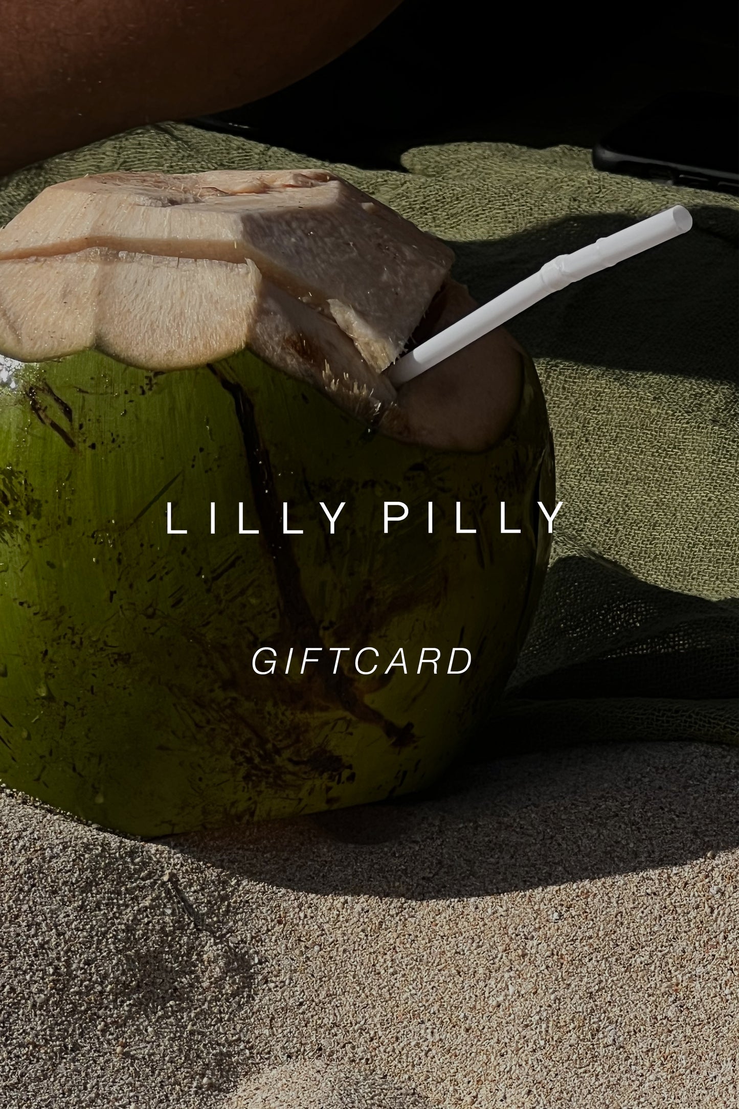 Gift card with a green coconut and leaf on a sandy background from Lilly Pilly.